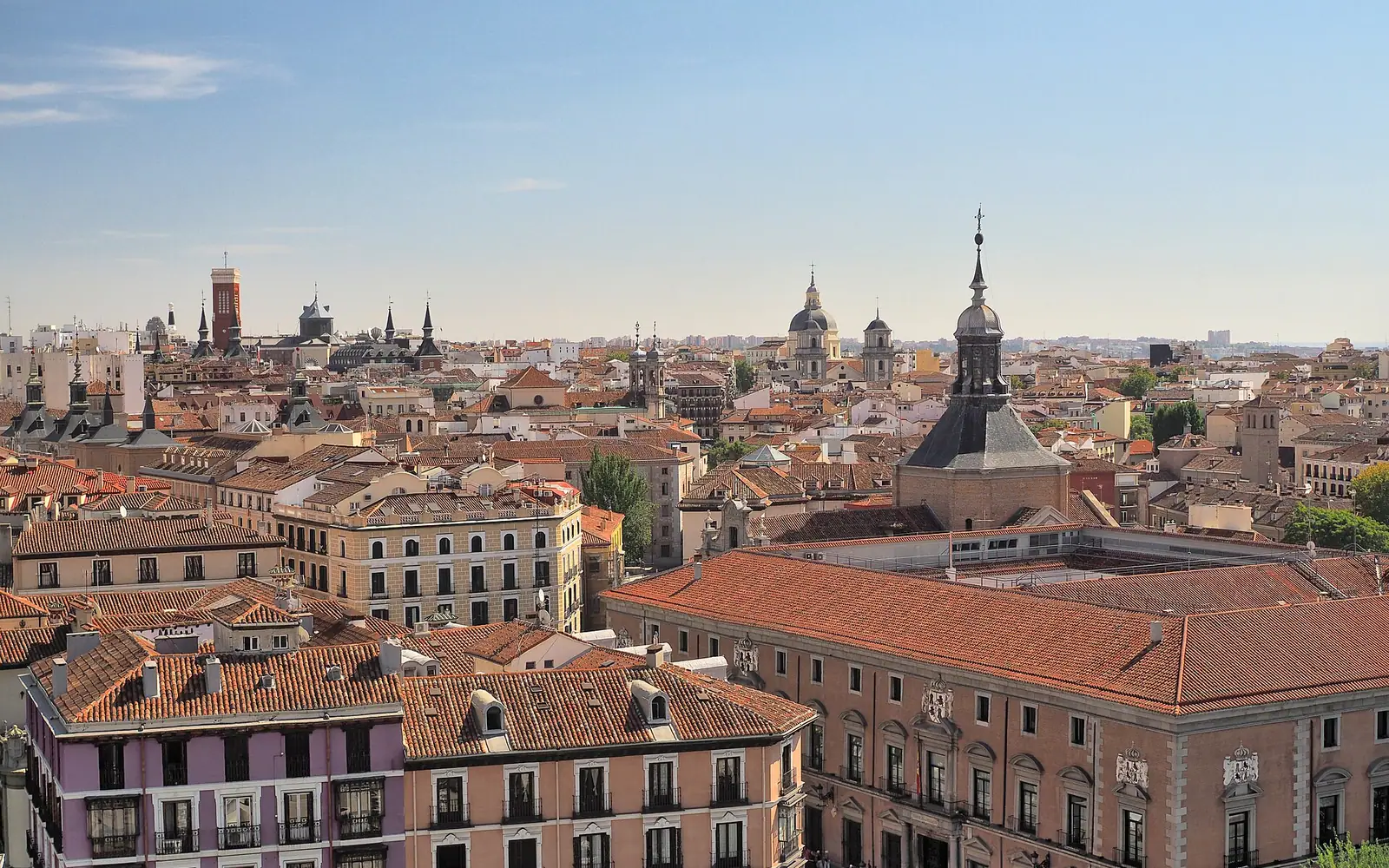 A nice view of numerous fine buildings with exterior balconies in Madrid , Spain .