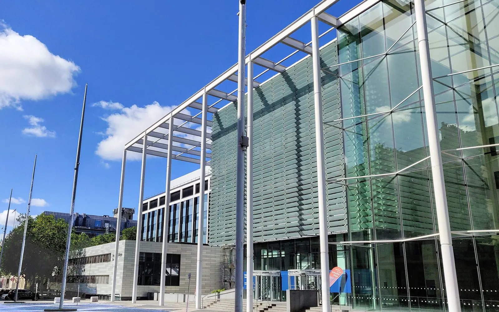 The main entrance and business school of Imperial College London along Exhibition Road. The City and Guilds Building is visible in the background.