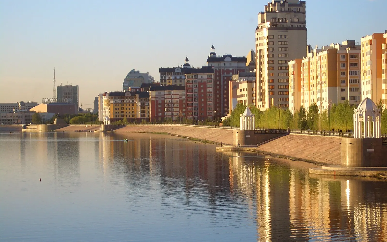New building along the embankment on the right (north) bank of the Ishim River in Astana , Kazakhstan . This roughly across the river from the city park.