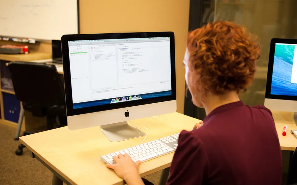 A female programmer writing Java code with JUnit