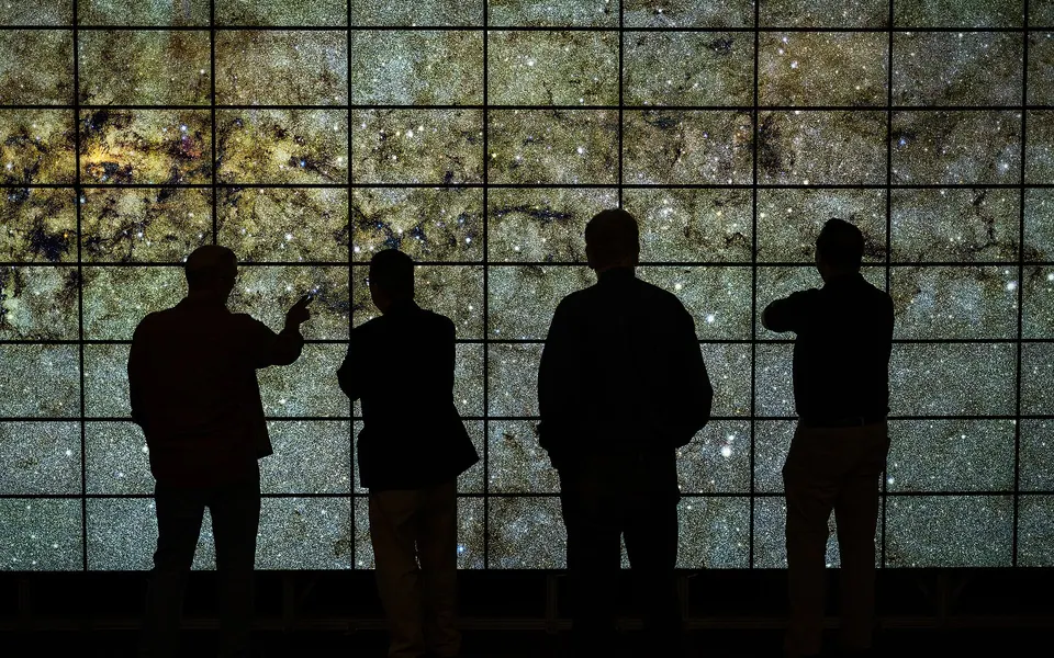 Chris Henze demonstrates the newly upgraded hyperwall visualization system to Center Director Eugene Tu, Deputy Center…